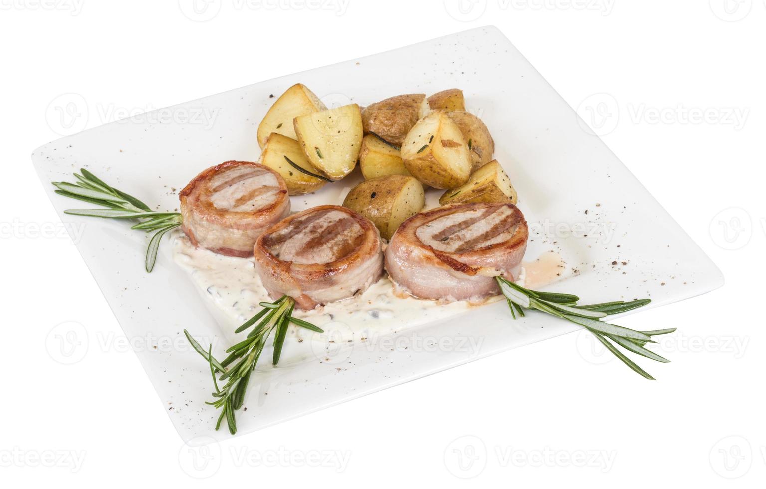 Grilled steak wrapped in bacon, with grilled vegetables, mashed potatoes photo