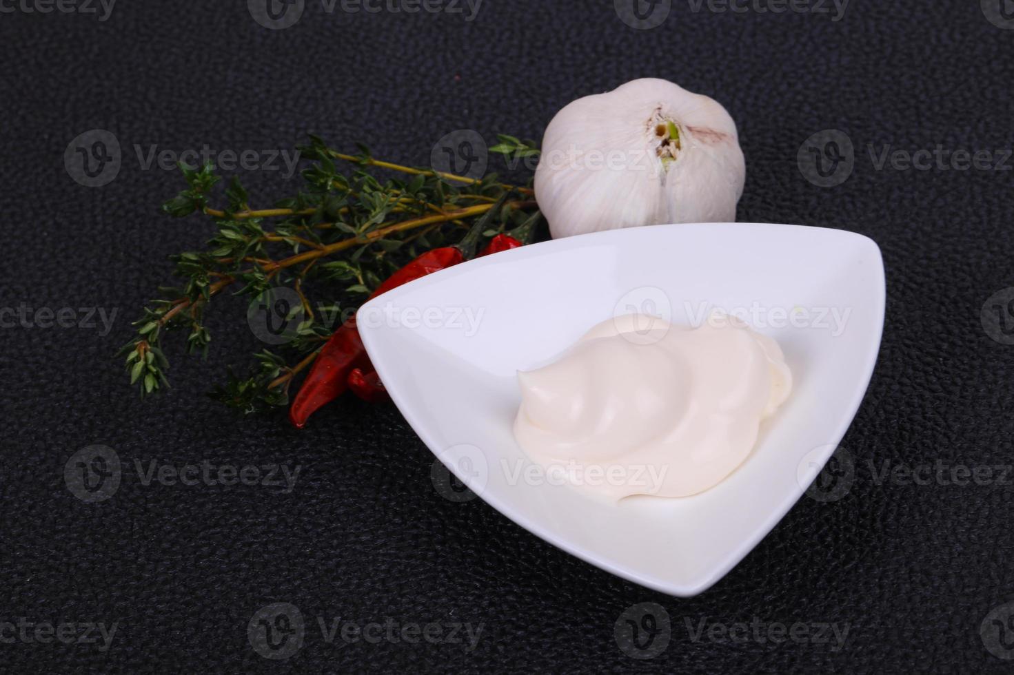 Mayonnaise sauce in the white bowl served thyme and garlic photo