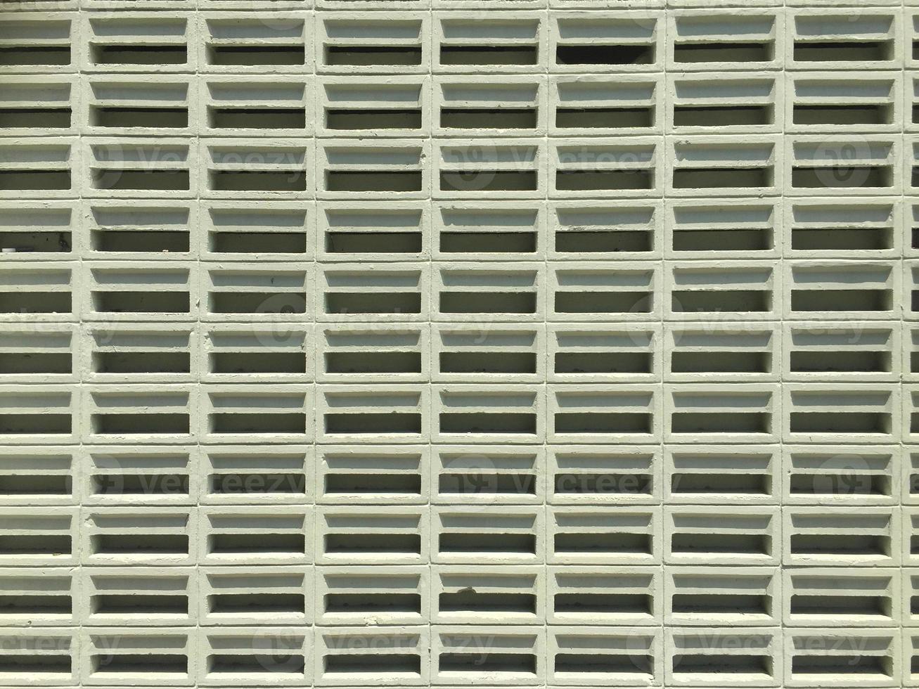 Front view of a series of light green concrete ventilation blocks photo