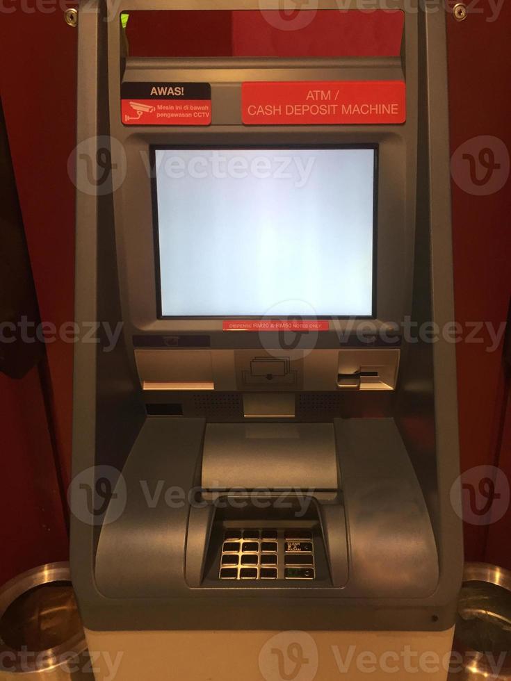 vista frontal de un cajero automático atm con pantalla blanca foto