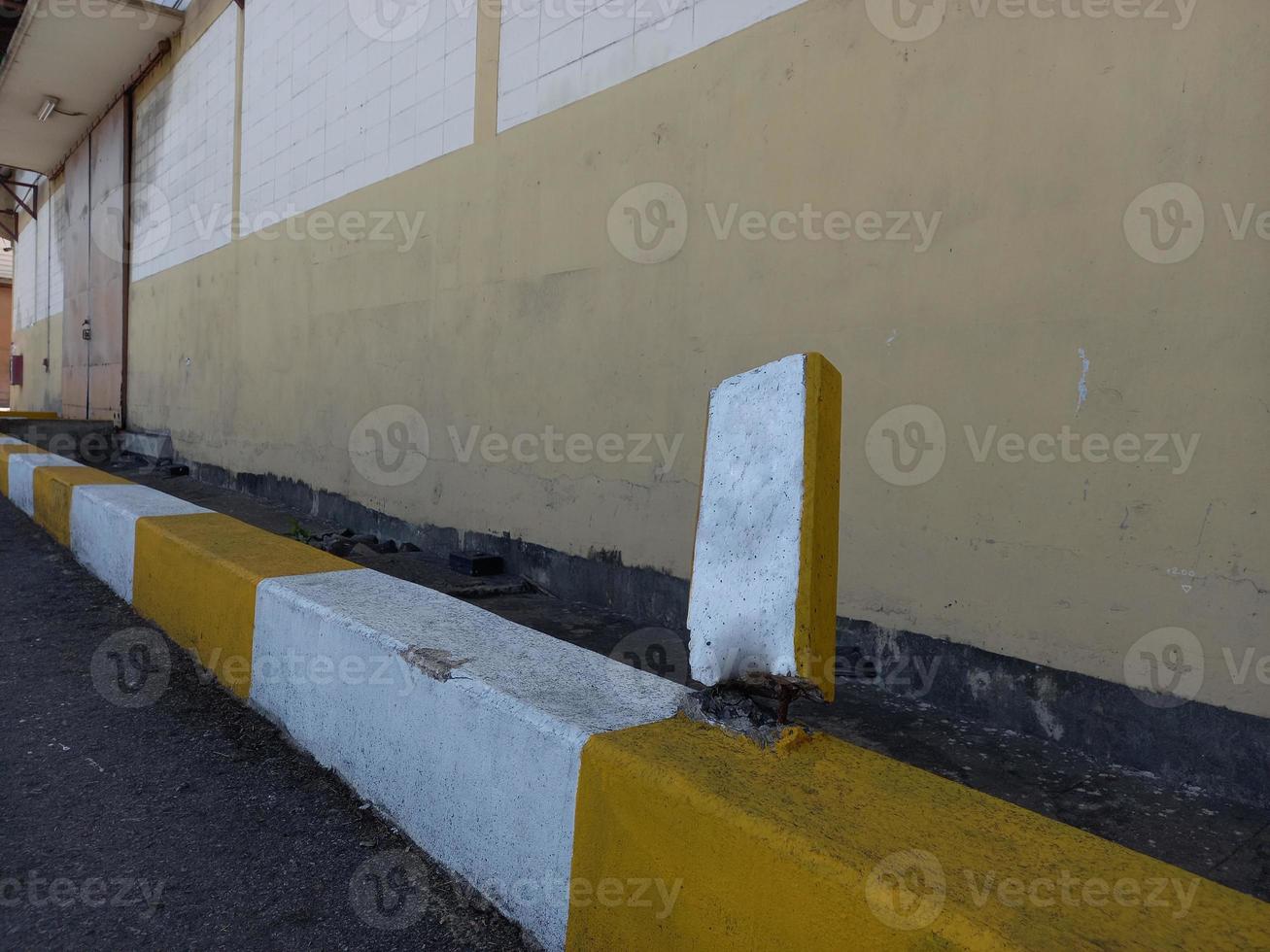 The damaged wall is visible to the internal steel bar. The plaster should be repaired to make it work. photo