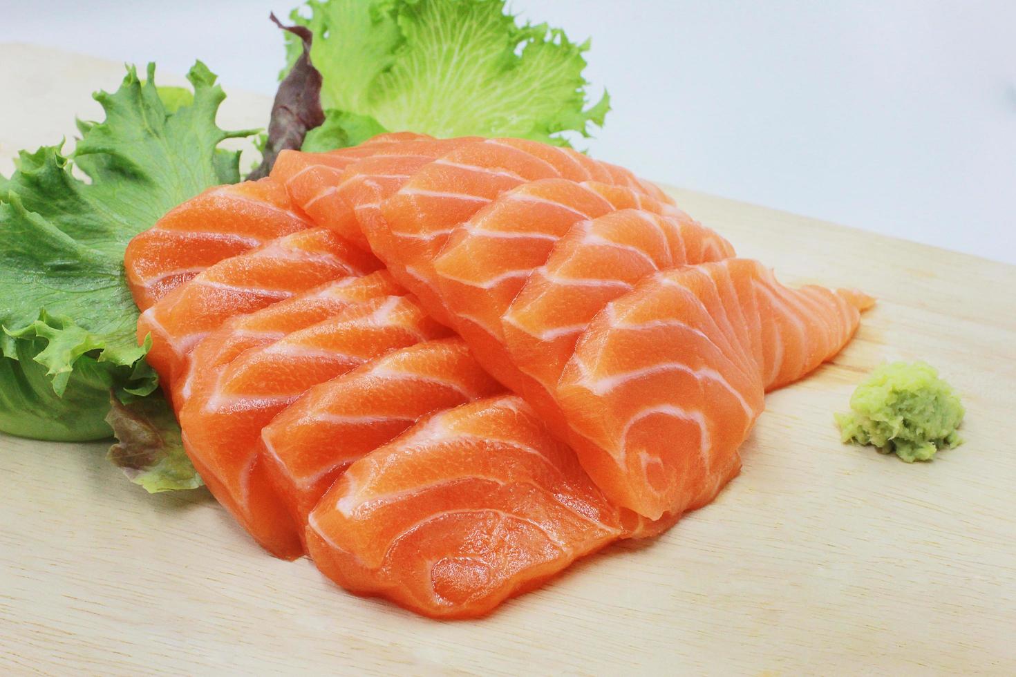 Fresh raw salmon fillet with Vegetables on the old wooden floor. photo