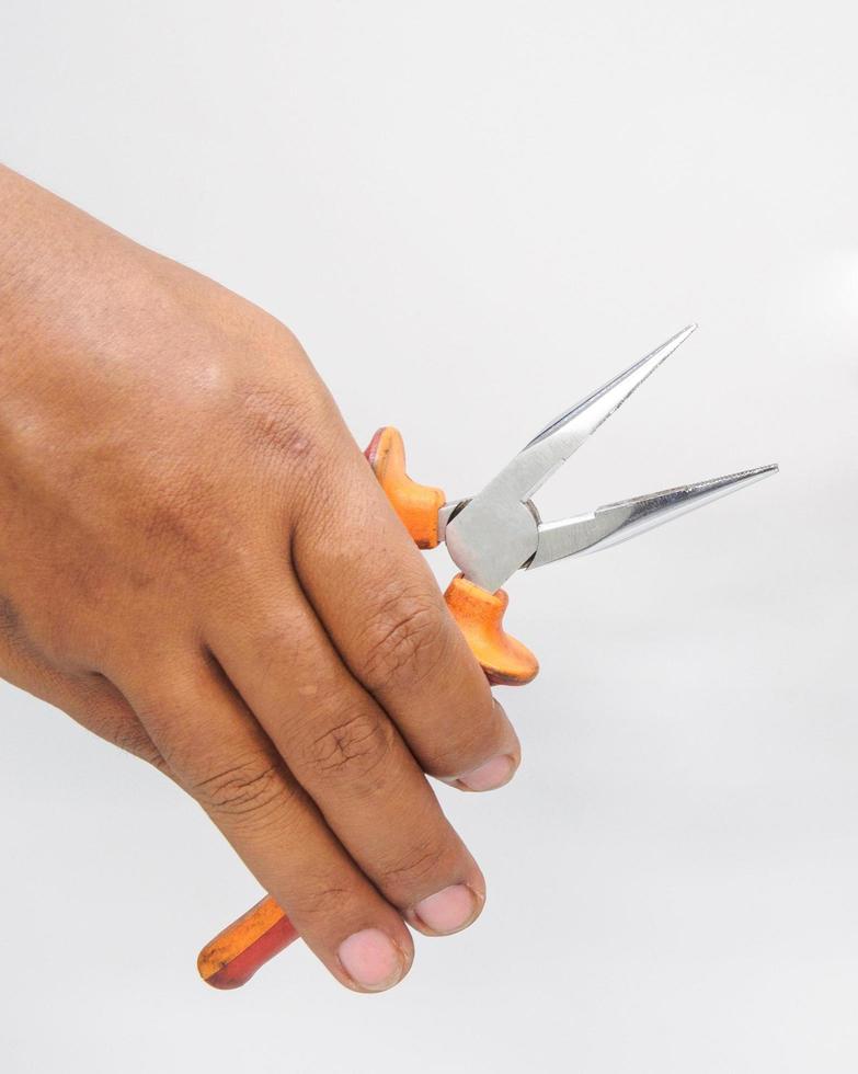 Hands Close-up Asian male mechanic holding tools pliers, electrician from industrial work on white background. photo