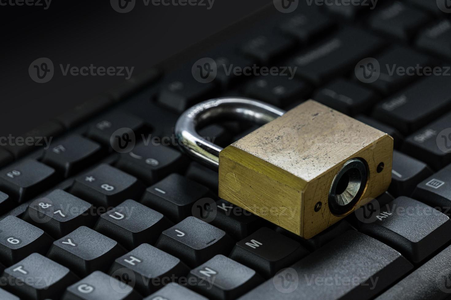 Master key on black keyboard, computer security privacy photo