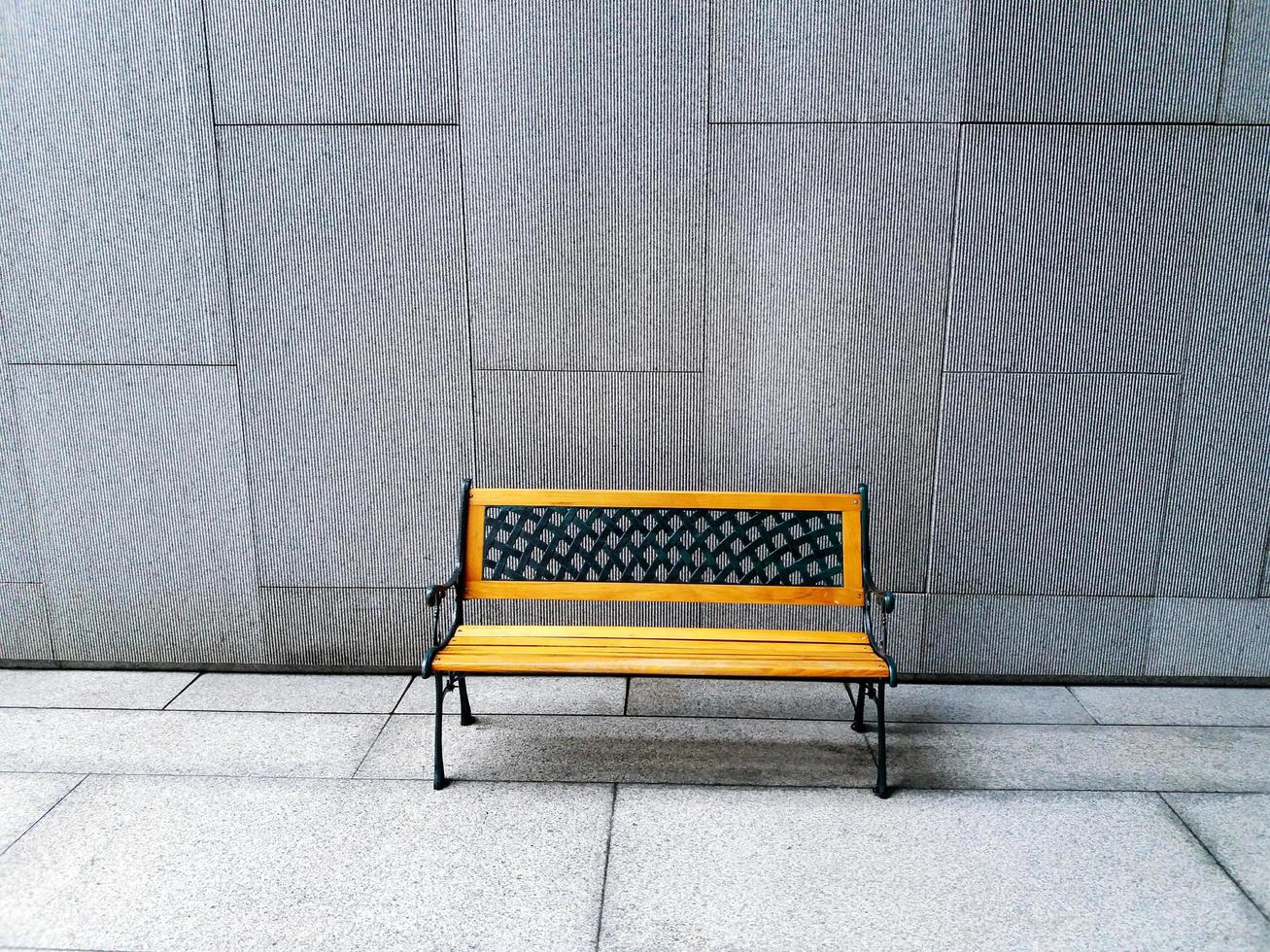 yellow vintage benches designed on textured concrete wall background and floor in with copy space. photo