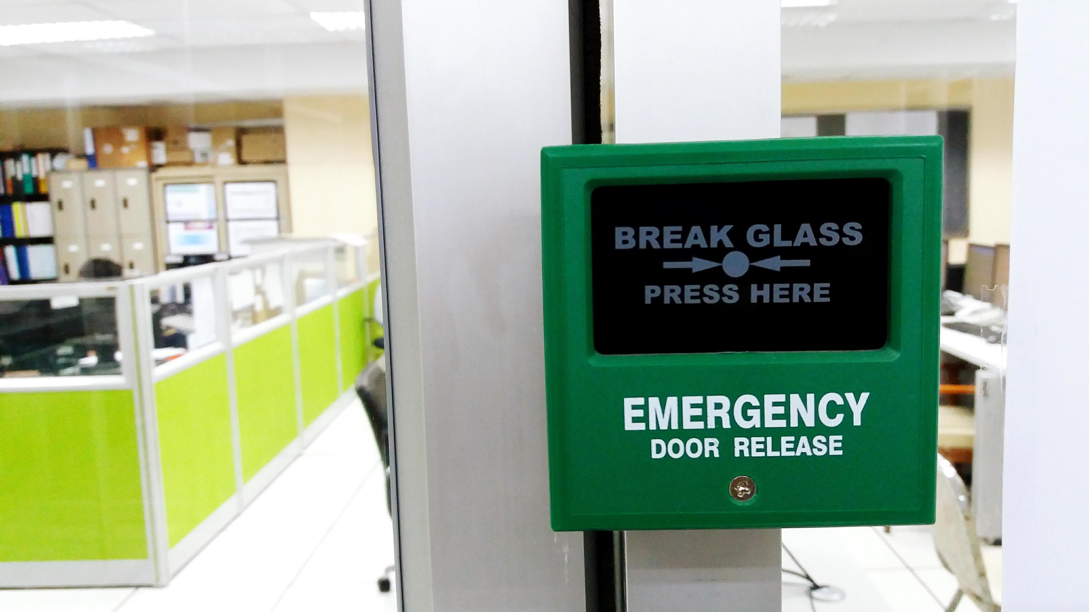 green emergency exit button to open door press here Stock Photo - Alamy