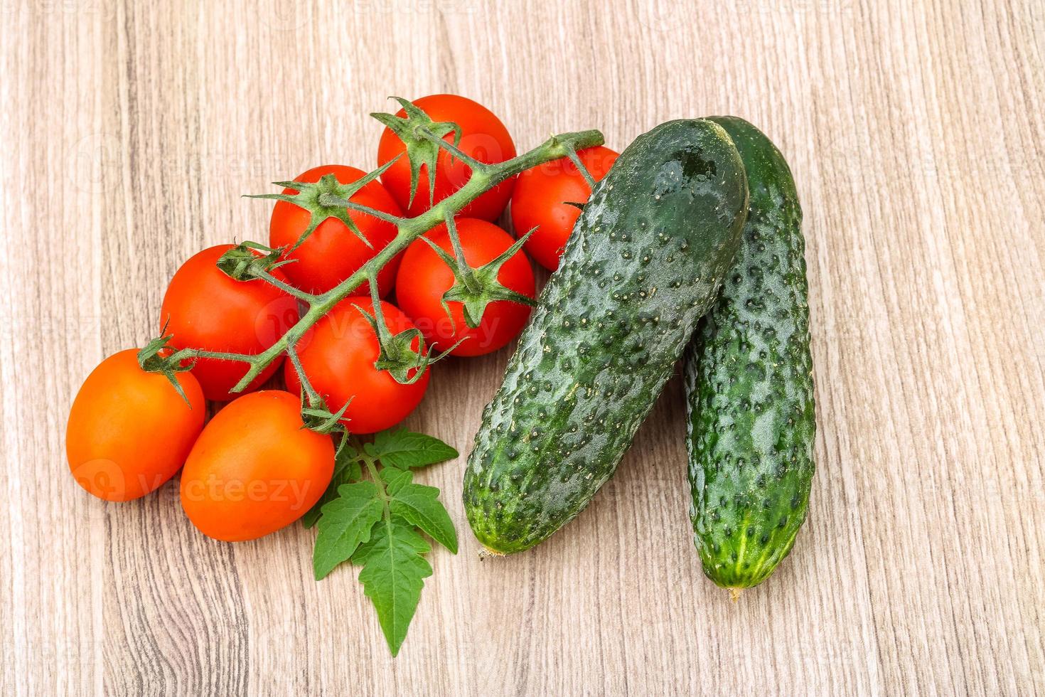 Cucumbers and tomatoes on the branch photo