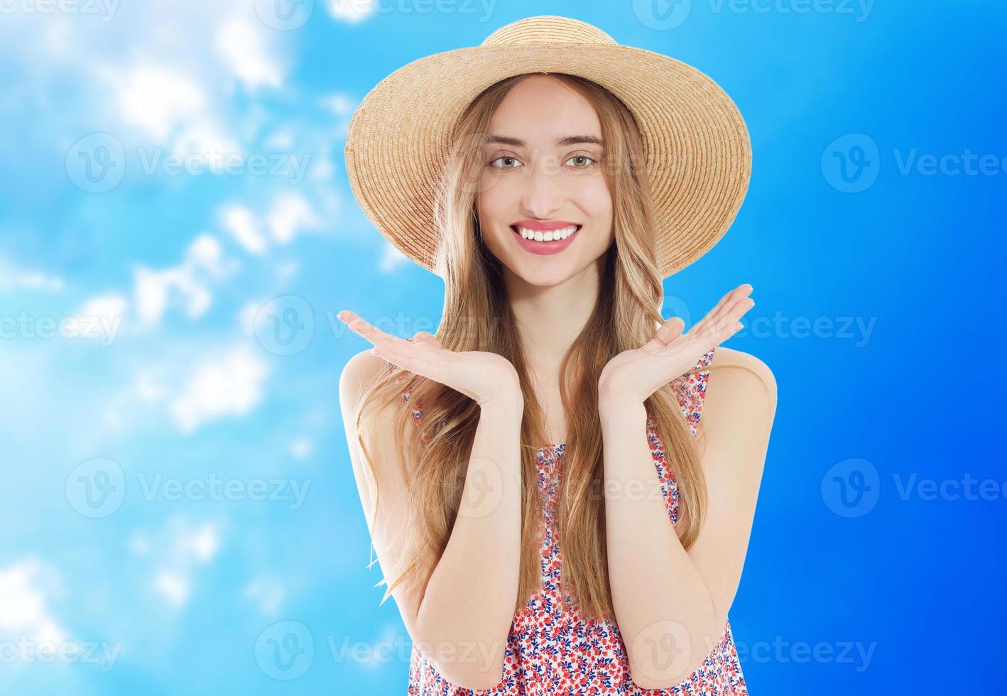 Beautiful asian woman withsummer hat smiling on a background of blue sky - summer concept photo