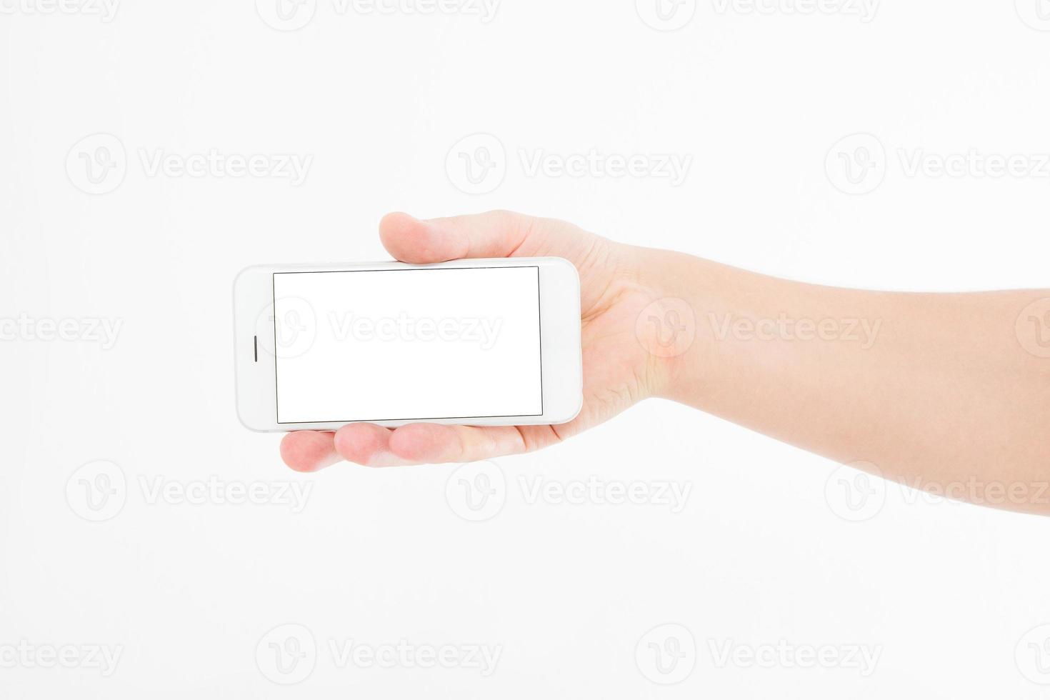 Hand holding white phone isolated on white clipping path inside. Top view.Mock up.Copy space.Template.Blank. photo