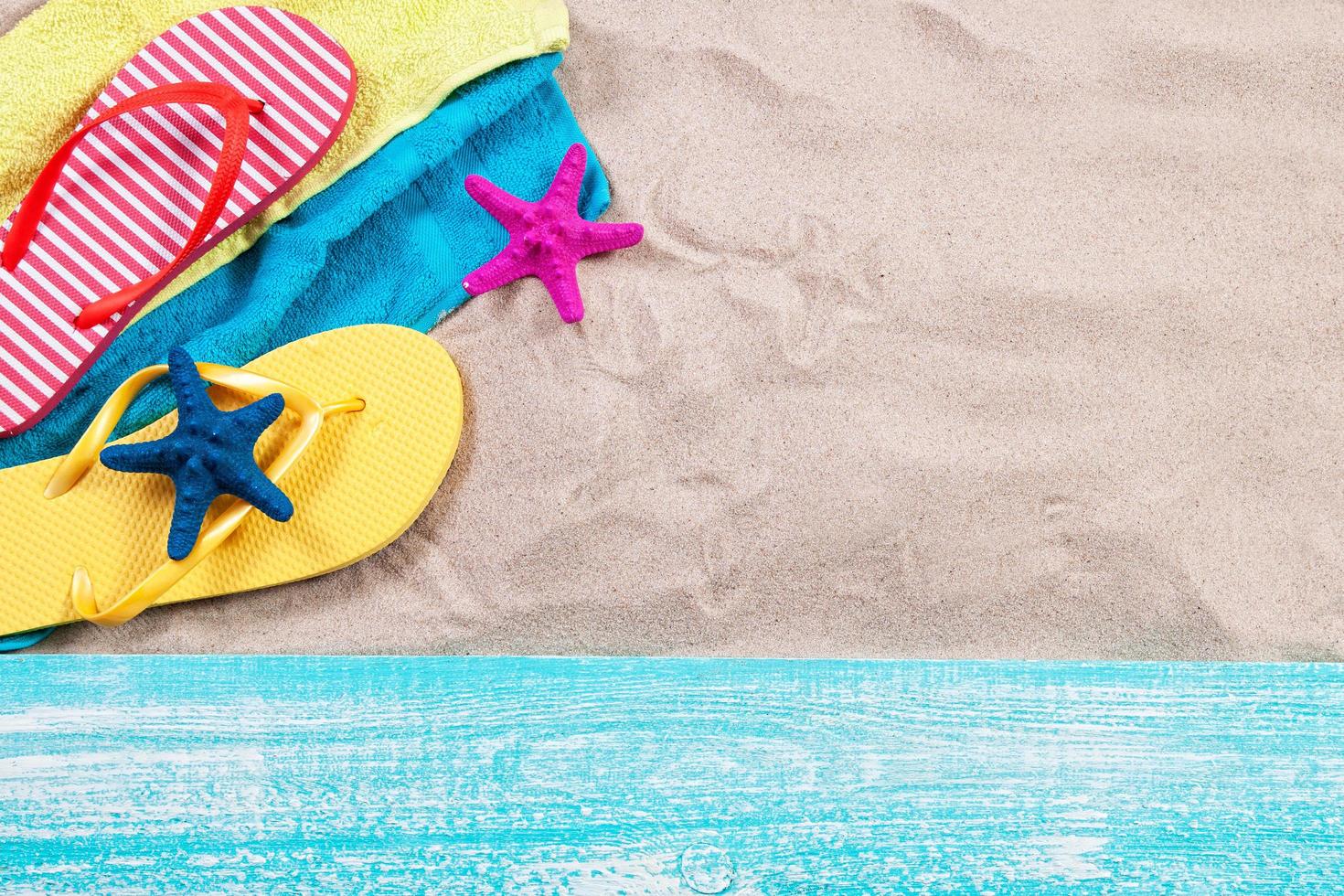 Sand copy space. Sand background top view.Beach towel, beach slippers and starfish photo