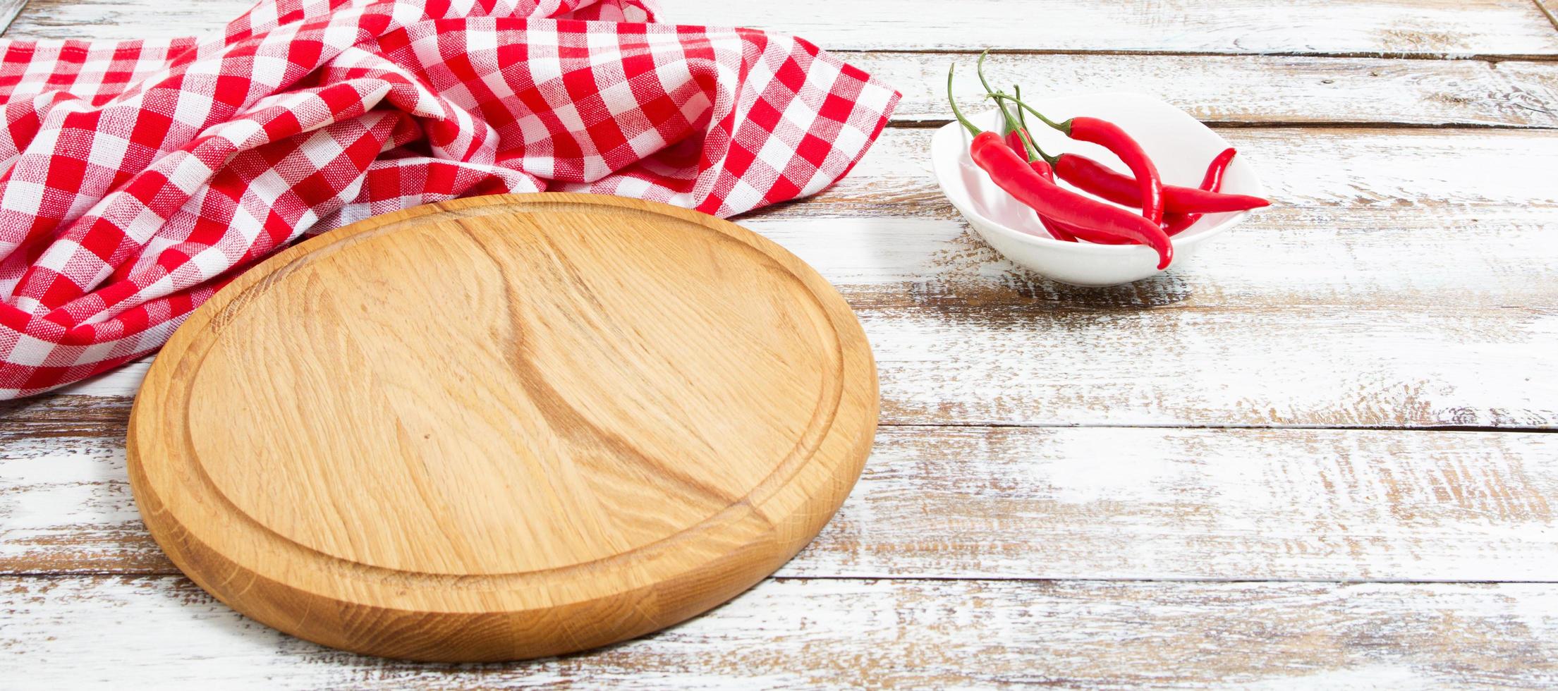 empty board and red hot pepper on an empty table photo