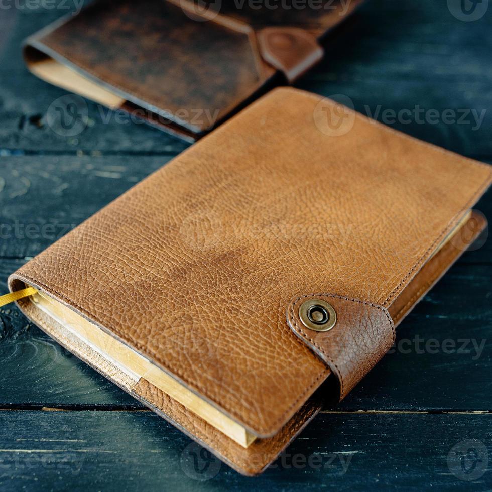 leather handmade notebook organizer on dark wooden background photo