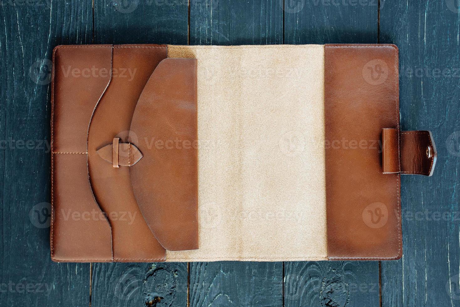 leather handmade notebook organizer on dark wooden background photo