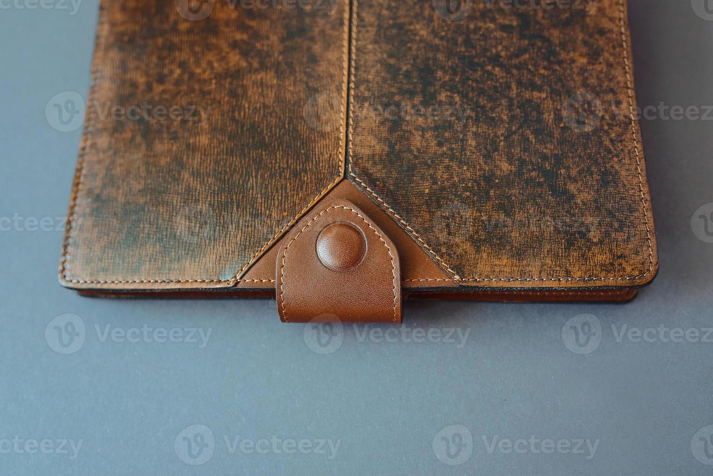 leather notebook on grey background photo