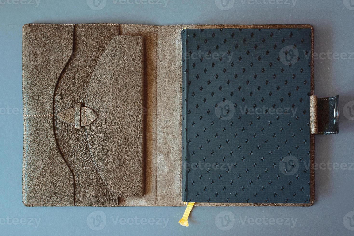 leather handmade notebook on dark wooden background photo