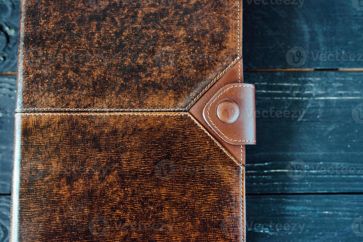 leather handmade notebook organizer on dark wooden background photo