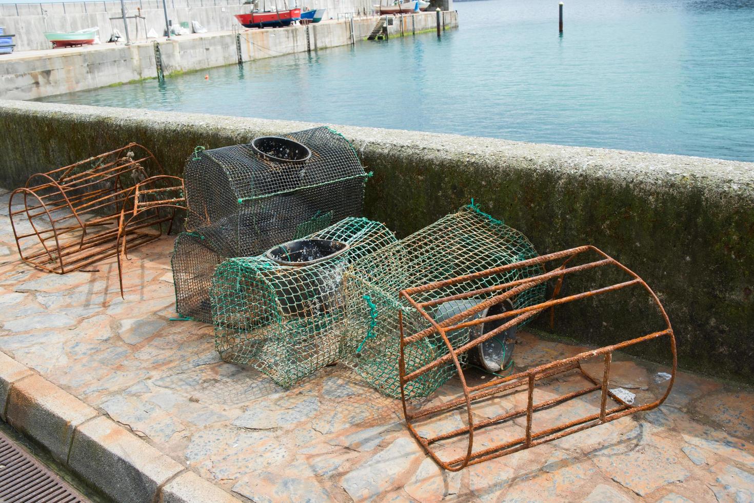 Old fishing cages, some of them without its net and rusty. Abandoned. photo