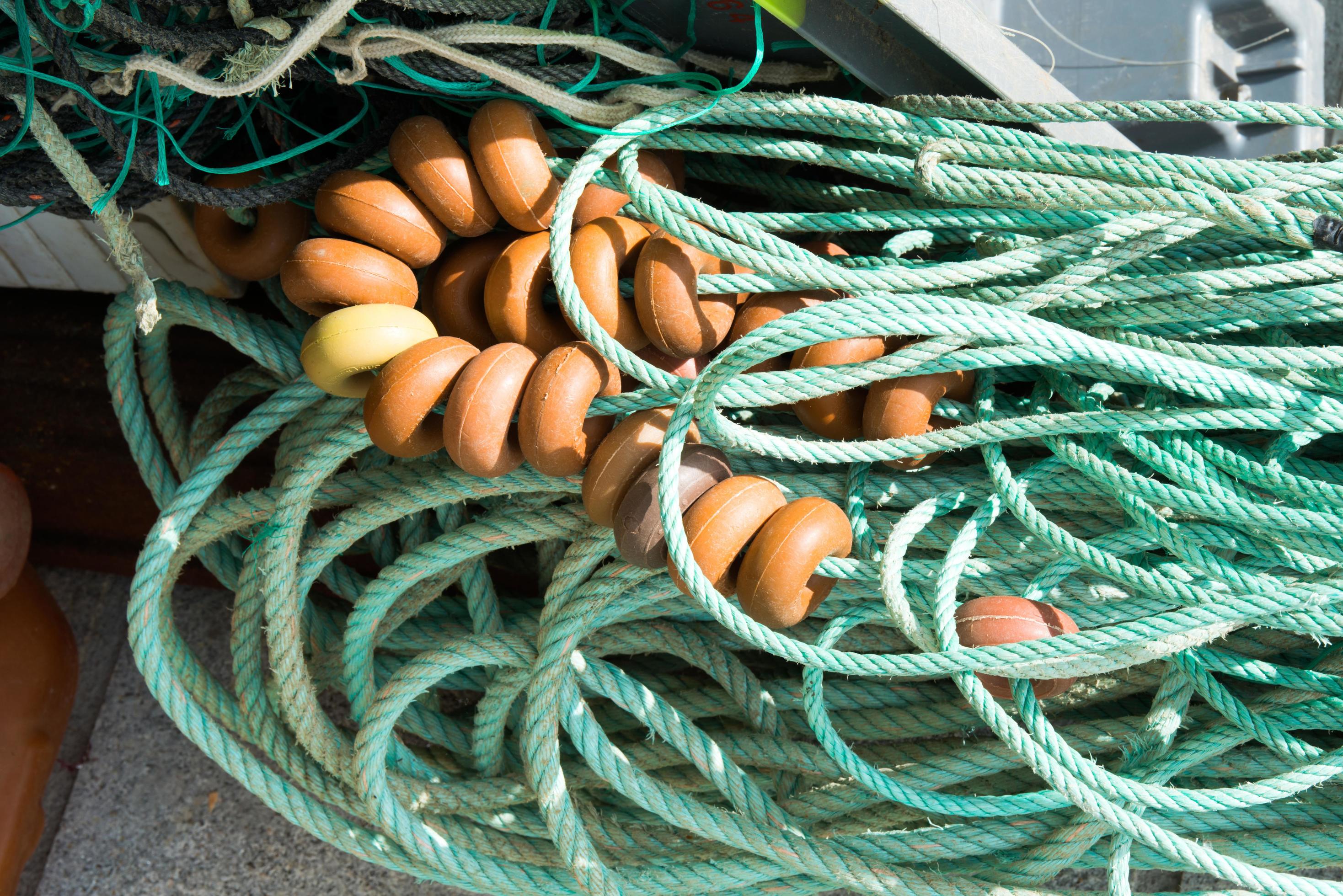 Used fishing net with pvc floats out of water for repair. Background  8530868 Stock Photo at Vecteezy