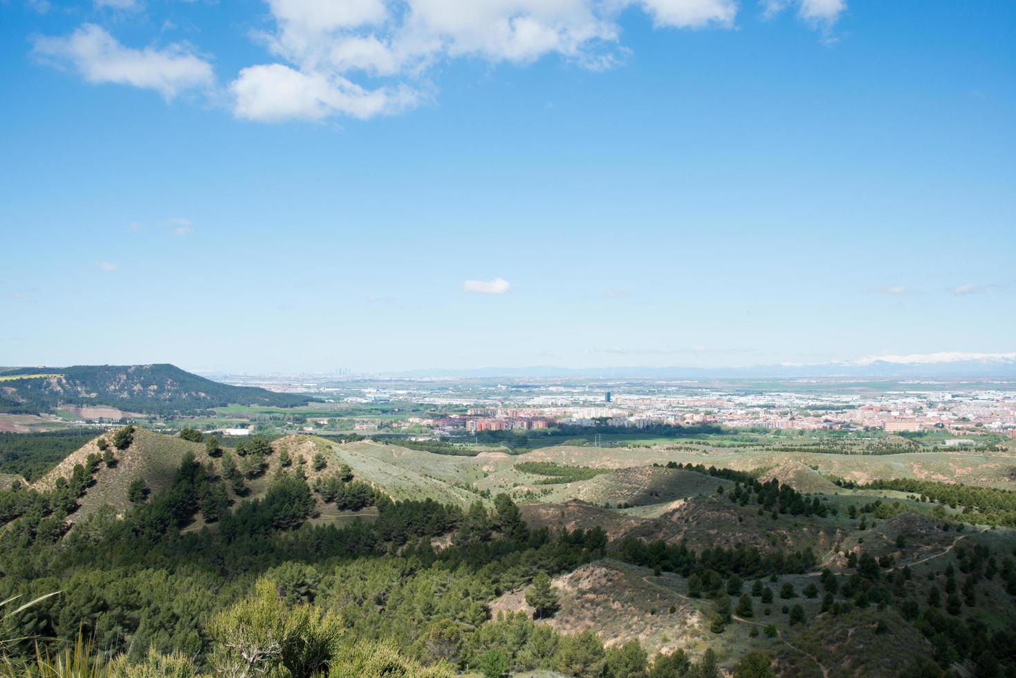 Beautiful landscape from a hill at Los Cerros Park, in Alcala de Henares. View of Madrid skyline and mountains with snow in the distance. Madrid photo