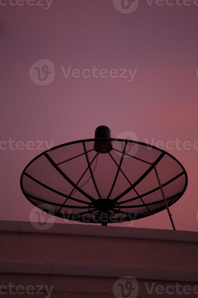 Satellite dish at sunset photo