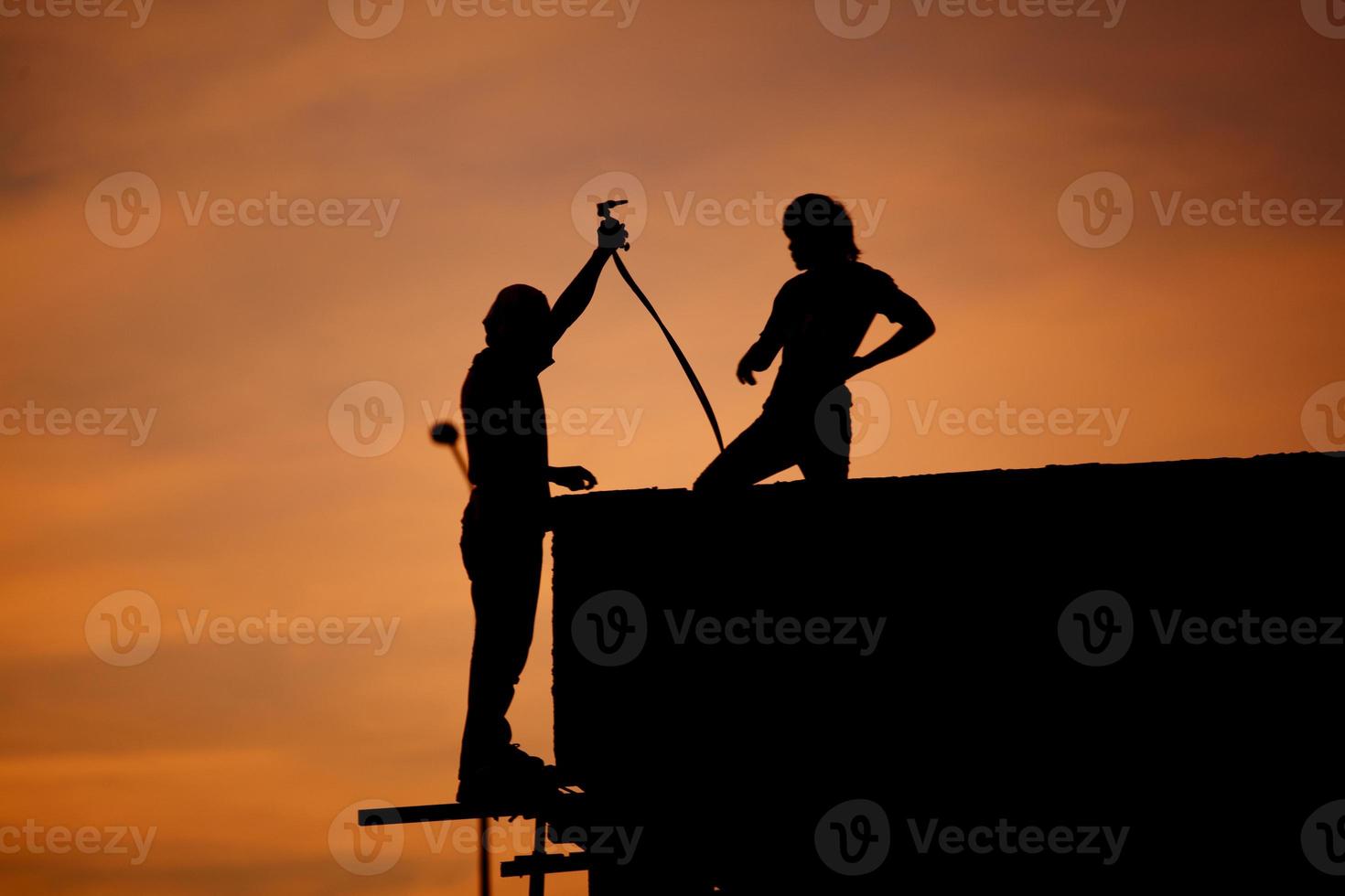 Silhouettes of worker welder photo