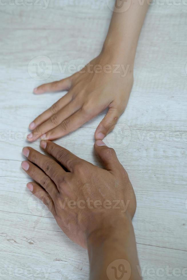 The hand gestures of the Asian man and woman are isolated over white background photo