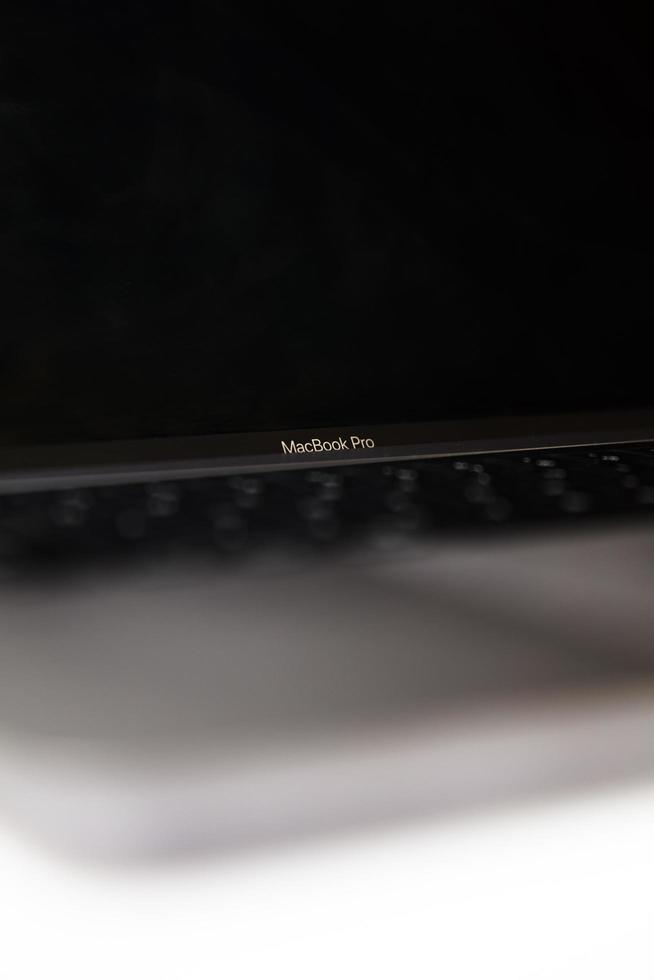 Belgrade, Serbia, 2020 - Detail of MacBook Pro computer isolated on white. The MacBook is a brand of notebook computers manufactured by Apple Inc. photo