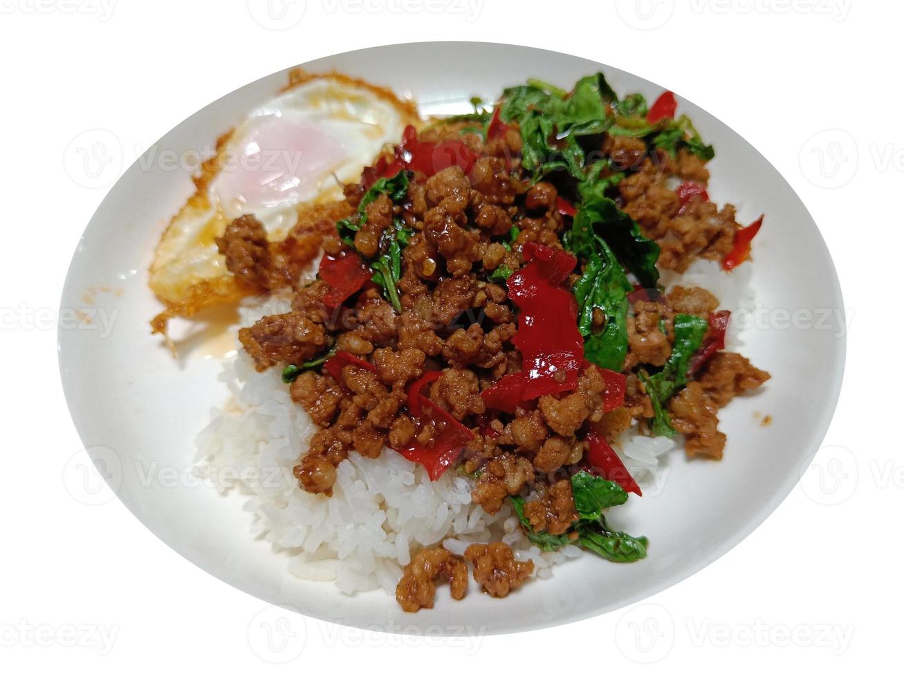 Stir fried minced pork and chili mix with basil on top steamed rice, hot and spicy, isolated on white background with clipping path photo