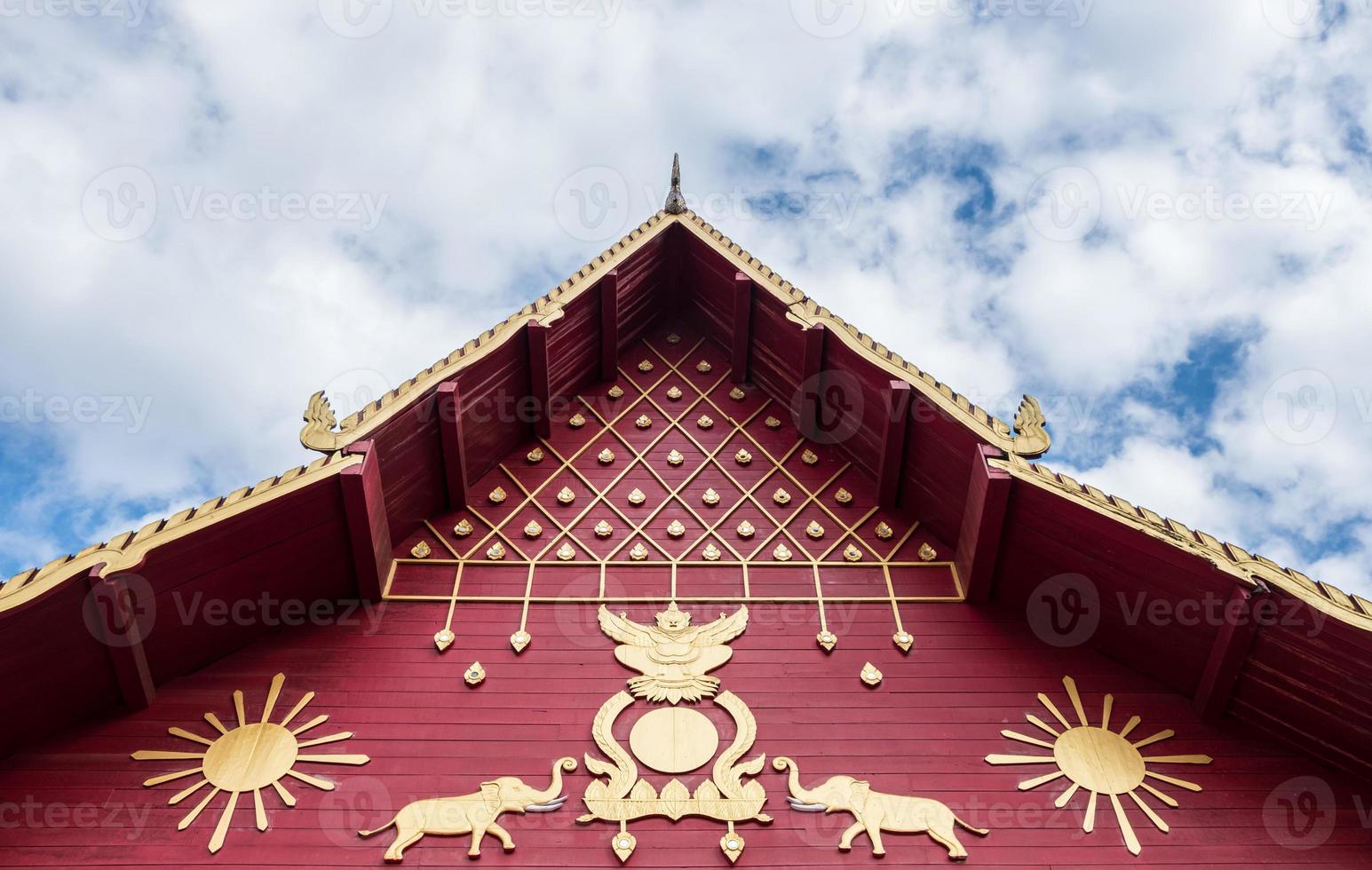 Carved pattern in the traditional Thai style on the gable of the Thai church. photo