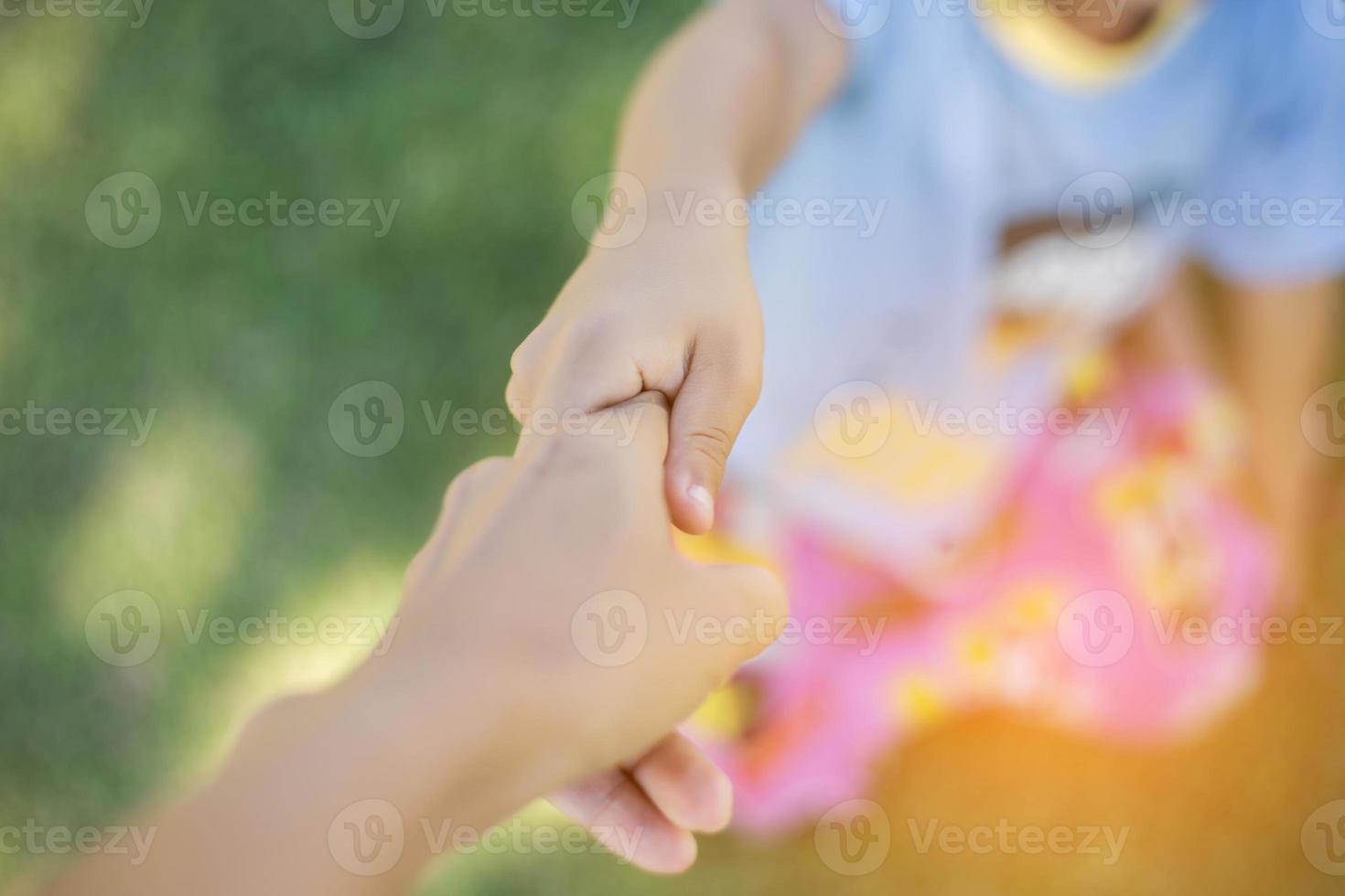 Happy boy child is smiling enjoying adopted life. Portrait of young boy in nature, park or outdoors. Concept of happy family or successful adoption or parenting. photo