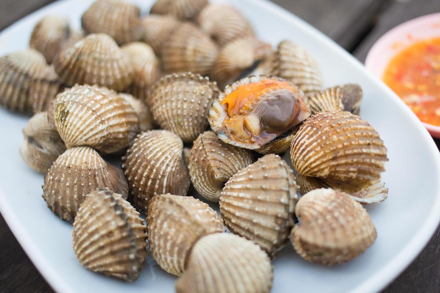 Boiled scallop is served with spicy sauce as a sea food in Thai style. photo