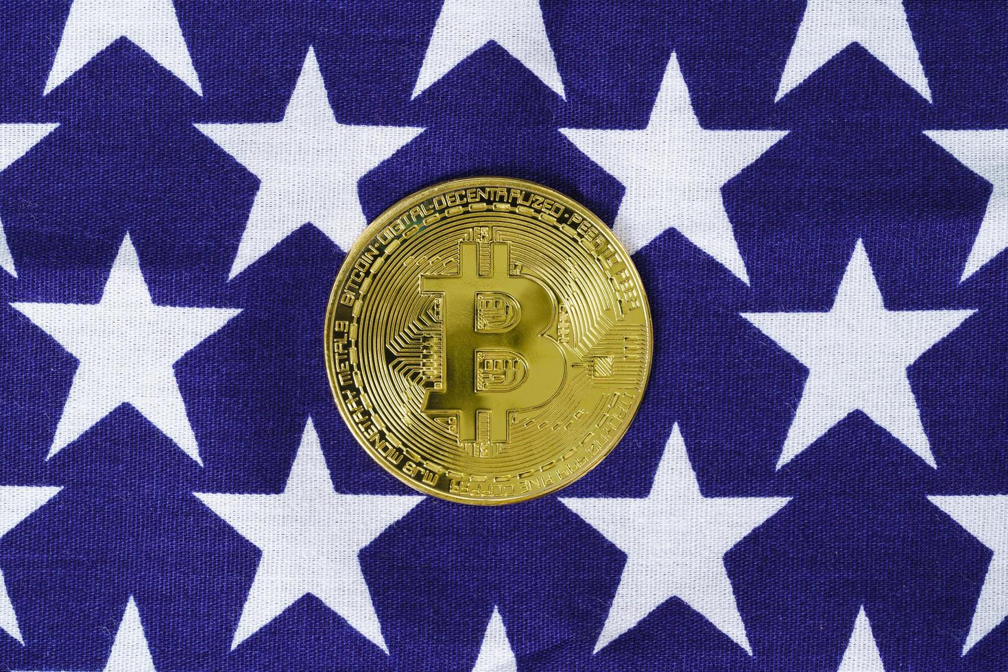 Gold Bitcoin coin on usa flag photo