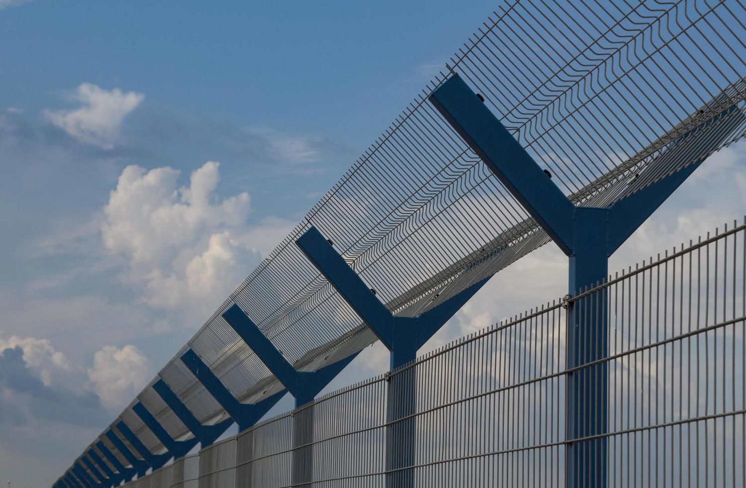 cage fence in fields, blue sky background photo