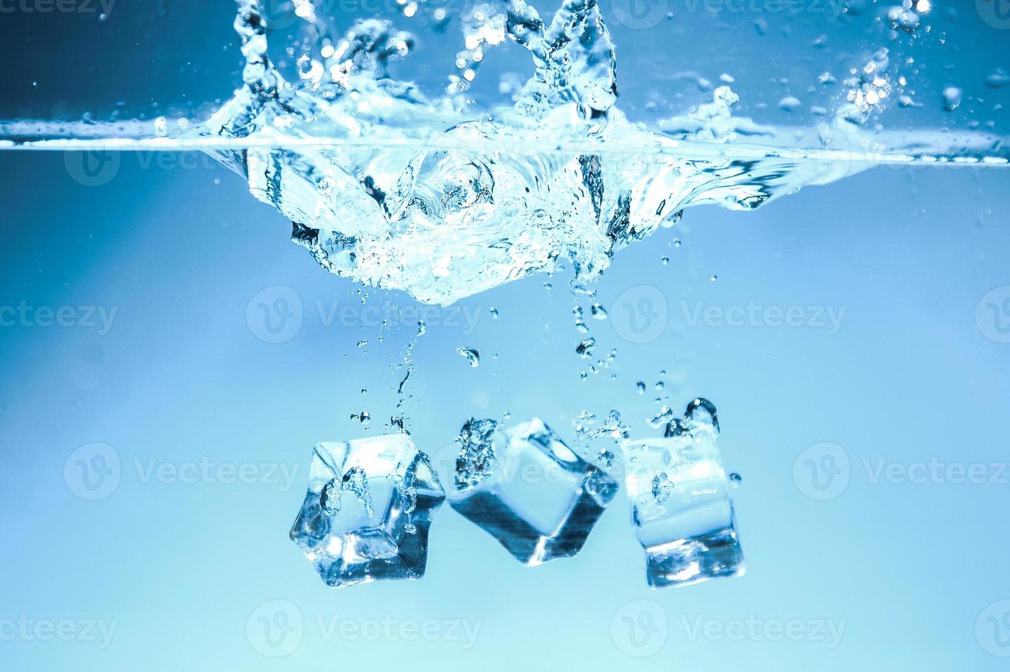 Abstract background image of ice cubes in blue water. photo