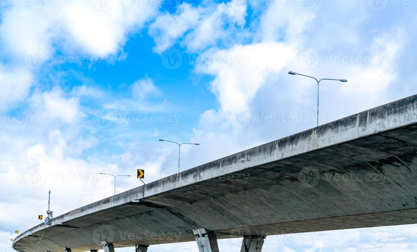 Bottom view of elevated concrete highway. Overpass concrete road. Road flyover structure. Modern motorway. Transportation infrastructure. Concrete bridge engineering construction. Bridge architecture. photo