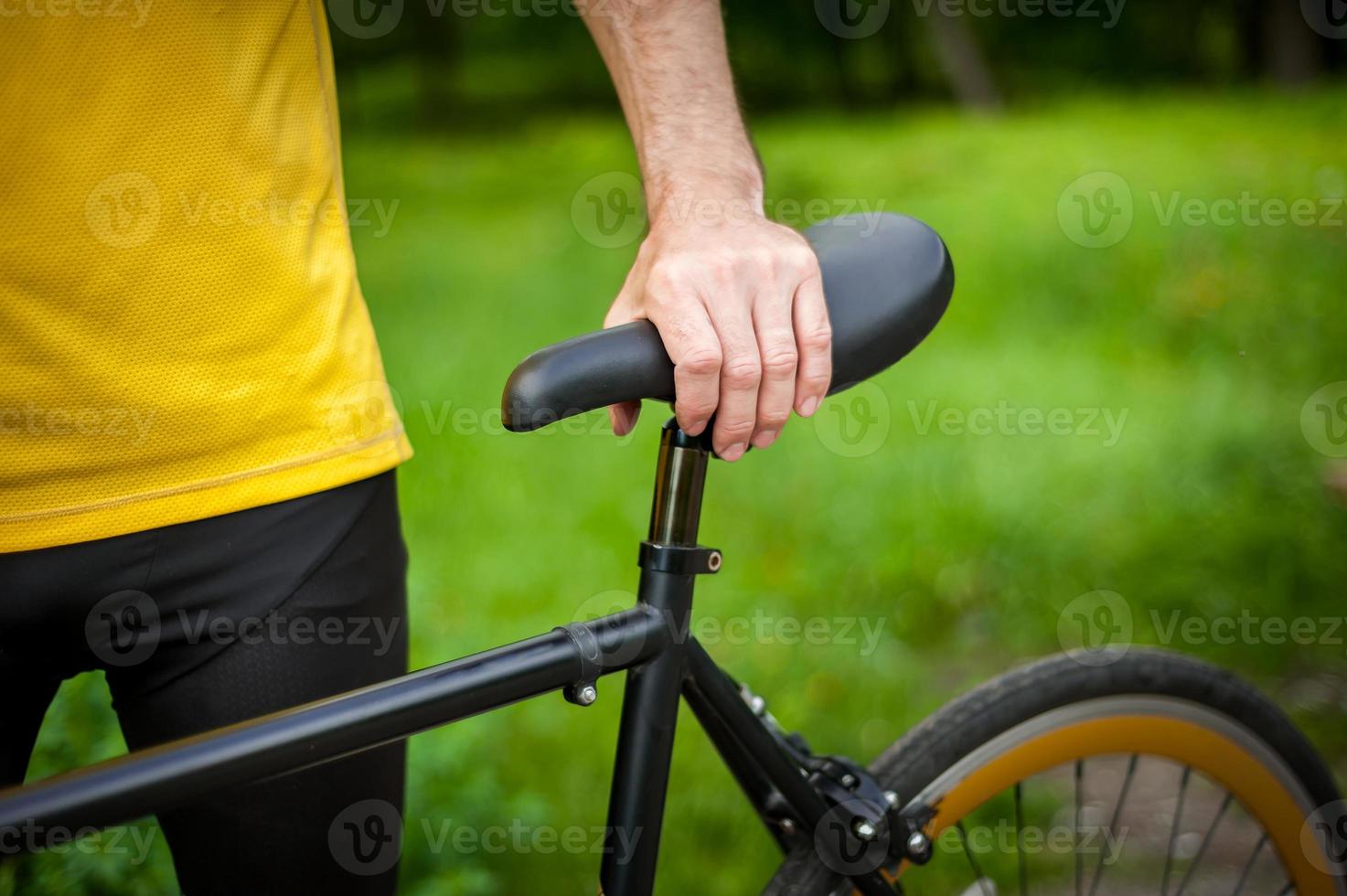 Cyclist with his bike, close up. Outdoor photography. photo