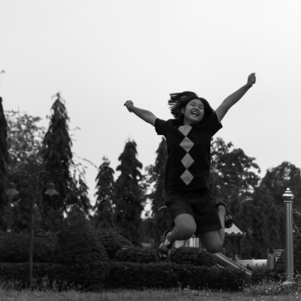 Black and white girl jumping happily. photo