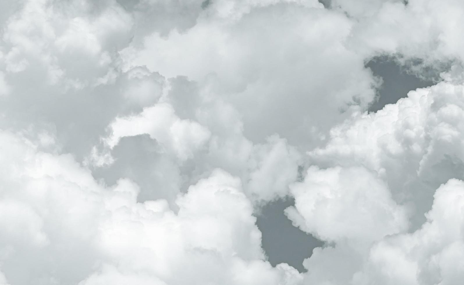 Grey and white fluffy clouds texture. Closeup detail of white clouds texture background. Soft-touch feeling like cotton. White puffy clouds. Gloomy and moody sky. Background for dead and tranquility. photo