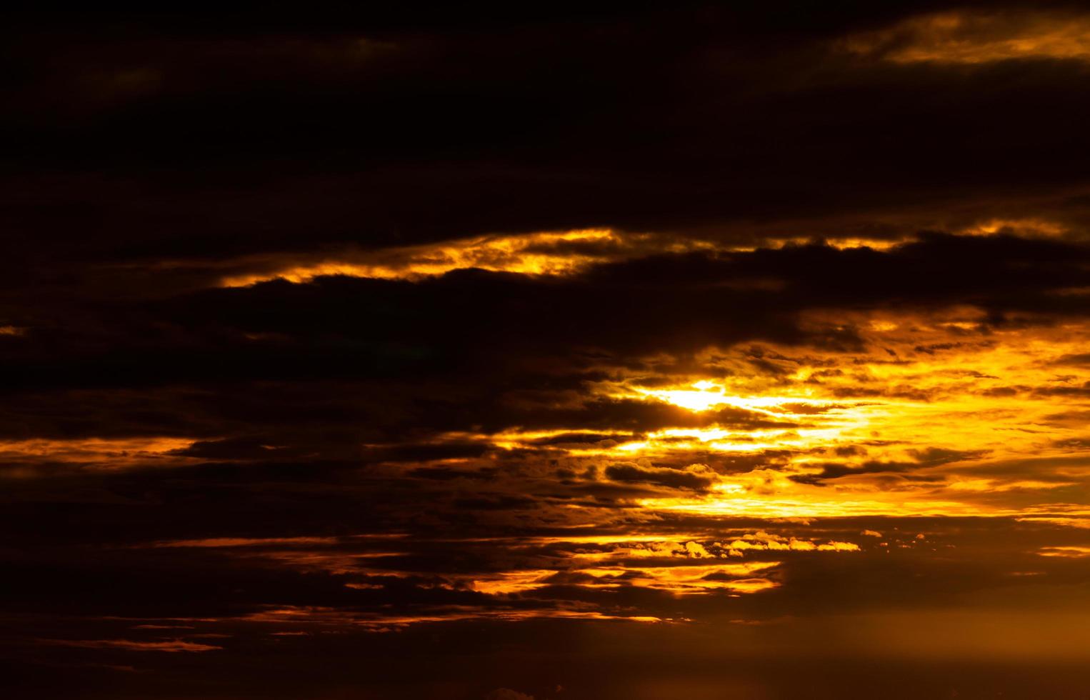Beautiful sunset sky. Golden sunset sky with beautiful pattern of clouds. Orange, yellow, and dark clouds in the evening. Freedom and calm background. Beauty in nature. Powerful and spiritual scene. photo