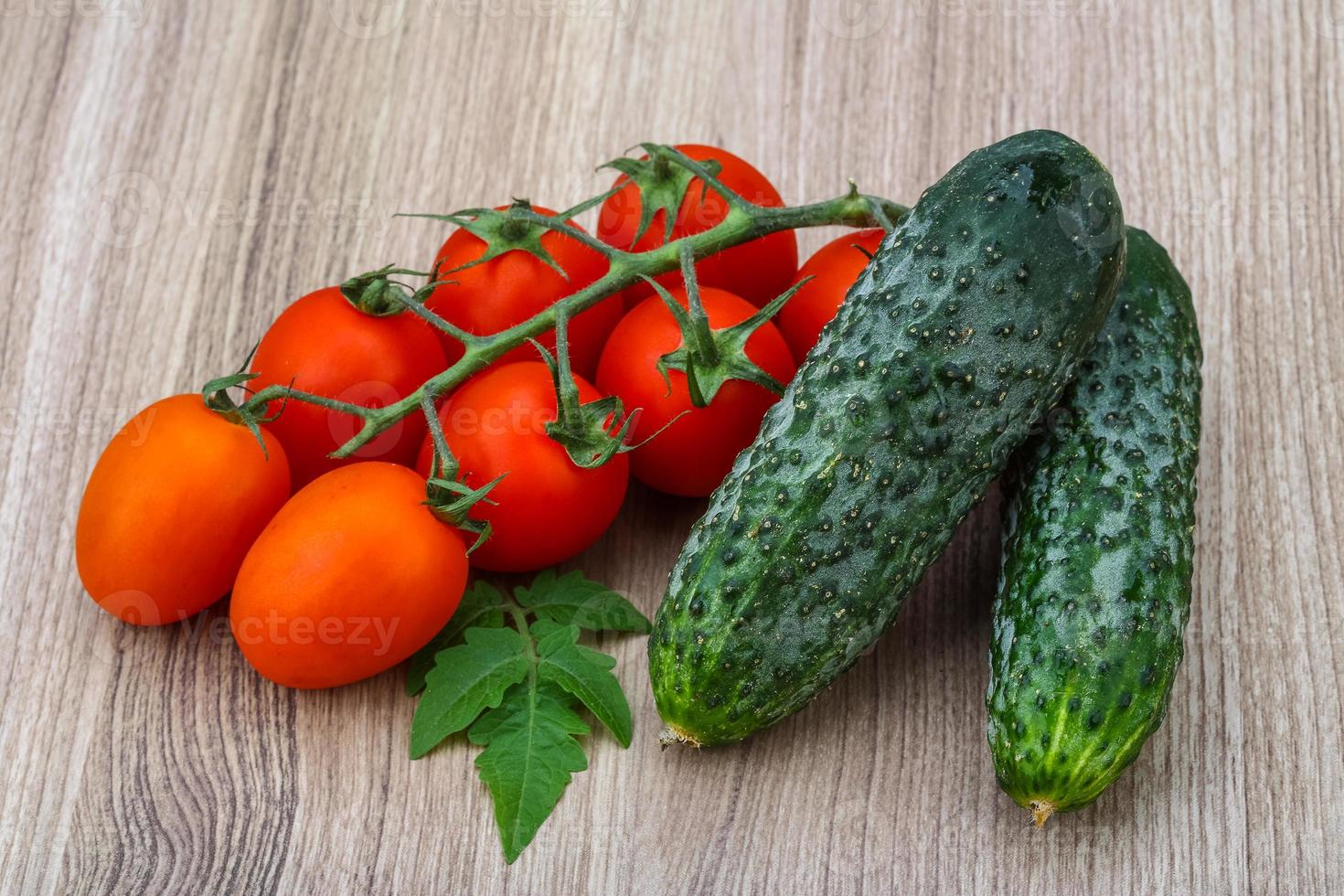 Cucumbers and tomatoes on the branch photo