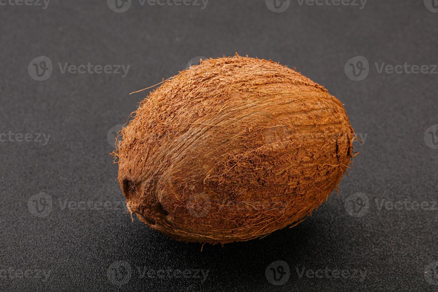Tropical brown coconut over background photo