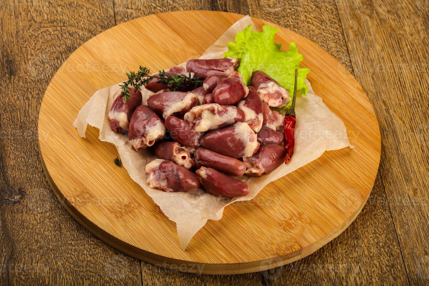 Raw chicken hearts photo