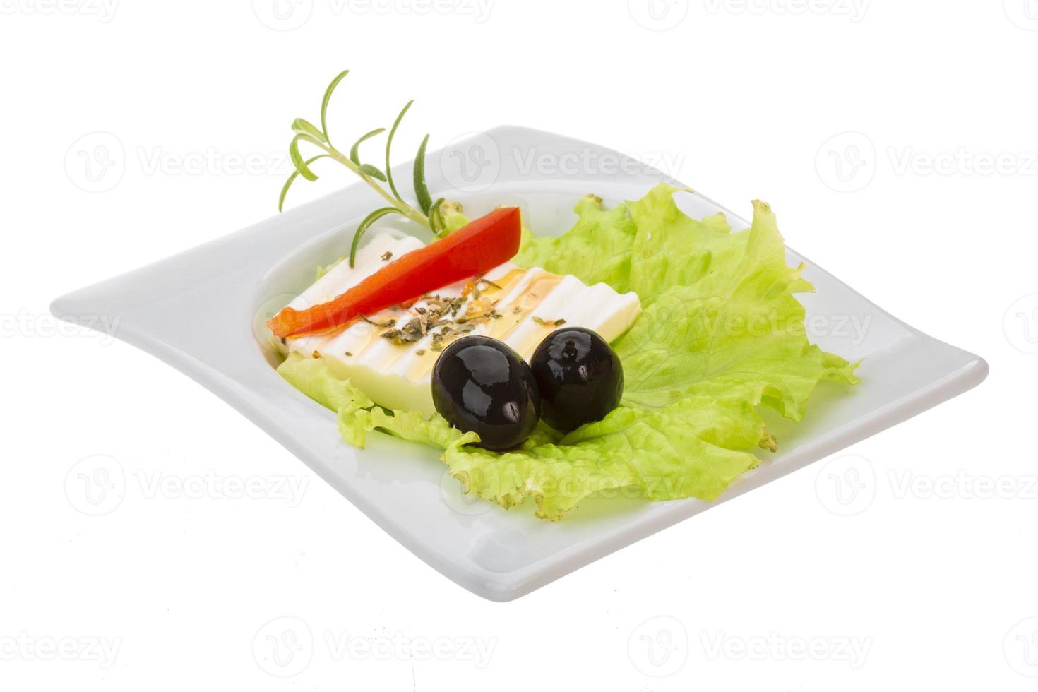 Soft cheese on salad with olives photo