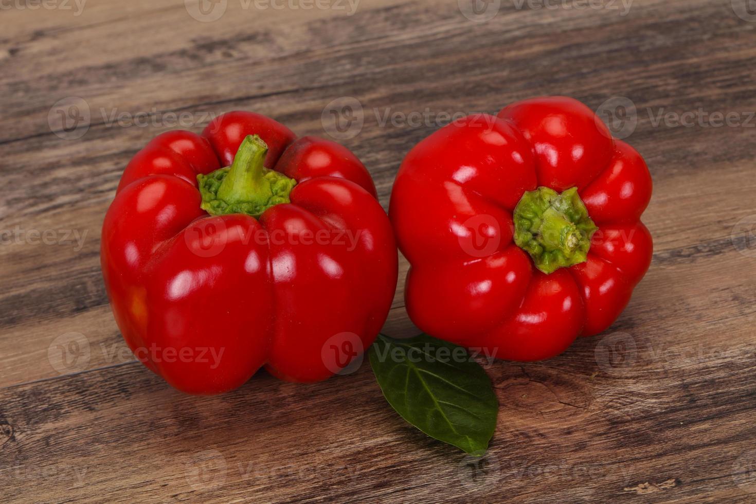 Ripe Red bell pepper over wooden photo