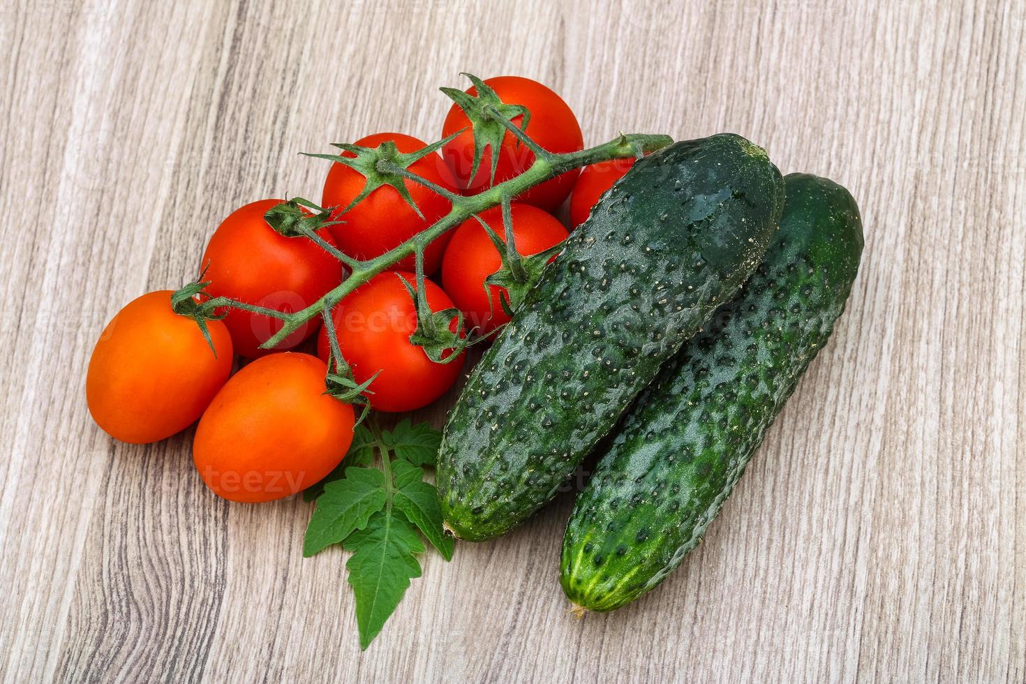 Cucumbers and tomatoes on the branch photo