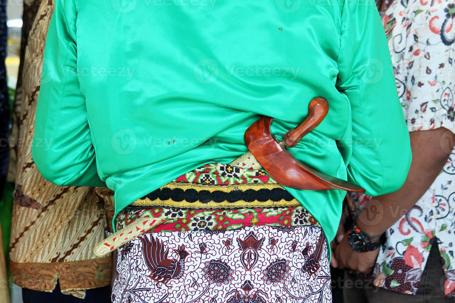 Beskap is an Indonesian traditional dress for the Javanese people. Keris is a traditional Javanese weapon that is usually tucked in a beskap. Usually used for traditional events such as weddings. photo