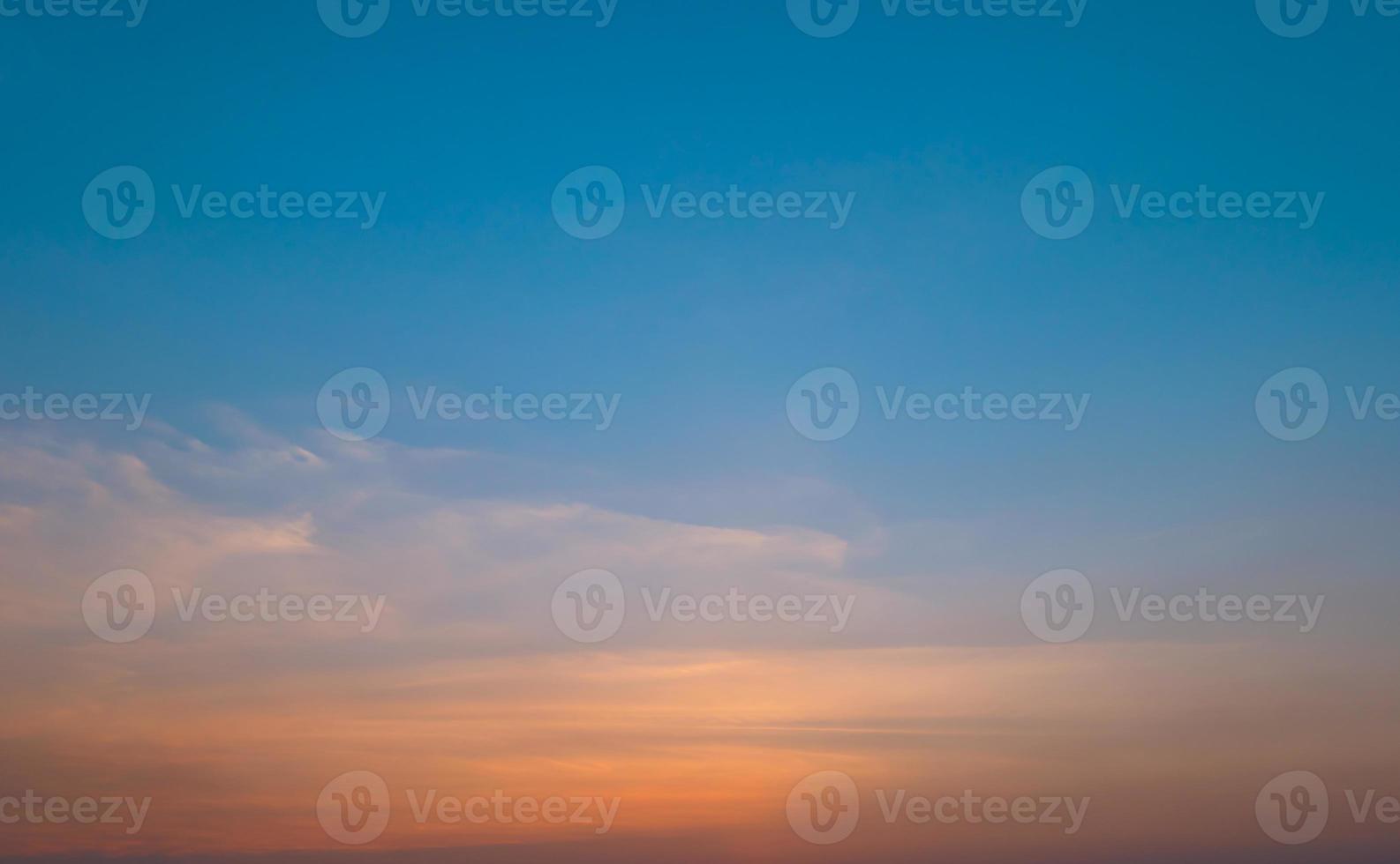 Bright orange sunset sky background with gentle colorful clouds, soft focus photo