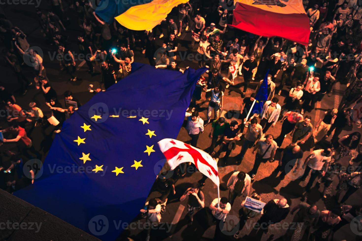 Tbilisi, Georgia , 2022 - Aerial view people march in streets on major EU-pro rally event. Thousands of people on peaceful demonstration event. Pro-Europe rally event in capital city Georgia photo