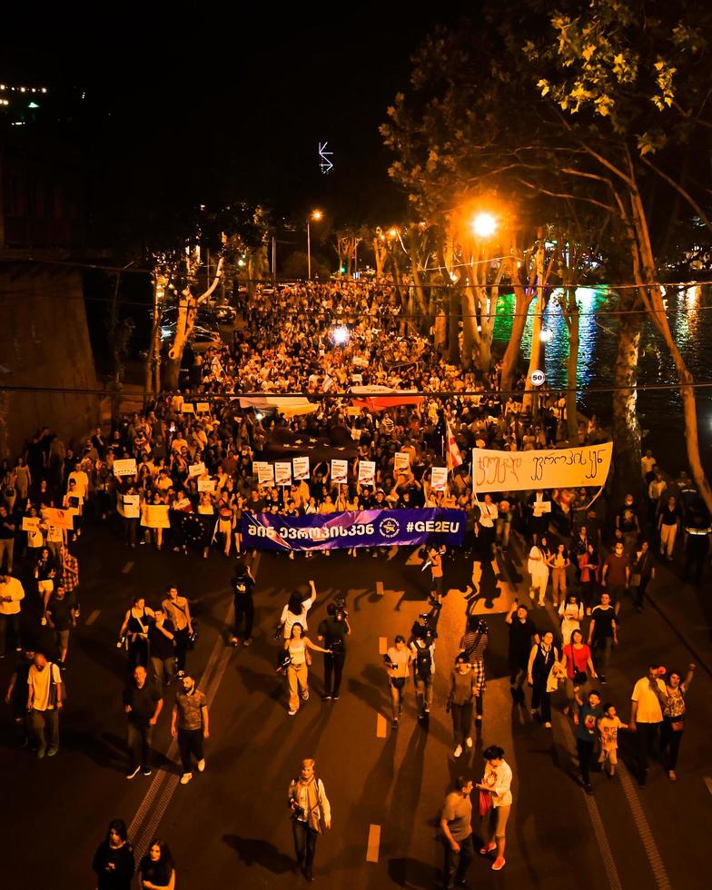 Tbilisi, Georgia, 2022 - Aerial view people march in streets on major EU-pro rally event. Thousands of people on peaceful demonstration event. Pro-Europe rally event in capital city Georgia photo