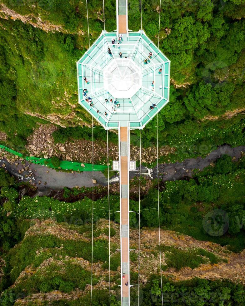 Dashbashi, Georgia, 2022 - Aerial top down view Diamond shape platform on glass bridge over scenic dashbashi valley in Georgia countryside. Famous modern bridge over valley in caucasus photo